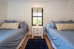 Bedroom with two double beds and night stand